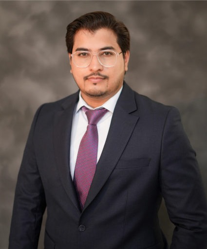 Close-up headshot of a Lynxsol team member wearing glasses and a suit